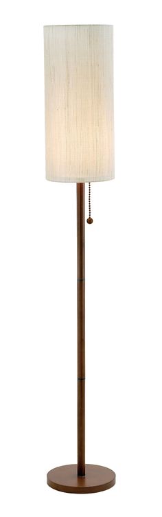 a lamp that is on top of a wooden stand with a white shade over it