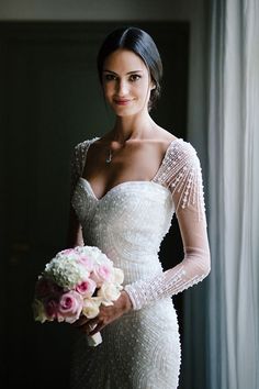 a woman in a wedding dress holding a bouquet