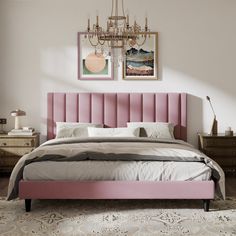 a bedroom with a pink bed and chandelier