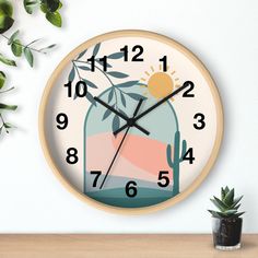 a clock on the wall with an image of a cactus in a jar and sun above it