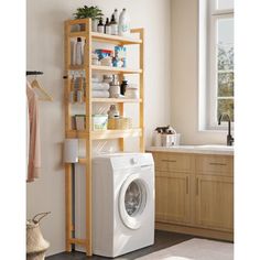 a washer sitting in front of a window next to a shelf filled with items