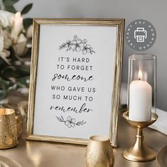 a gold table with a framed quote and candles