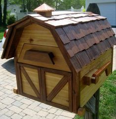 a wooden birdhouse with a brown roof