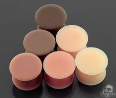 several different types of soaps sitting on top of each other in front of a black background