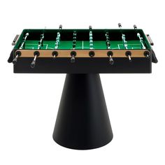 a foosball table sitting on top of a black pedestal with green and gold trim