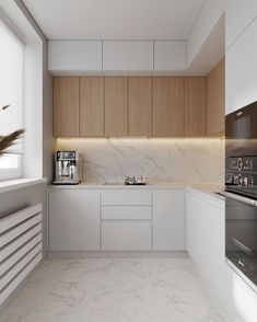 a kitchen with marble counter tops and white cabinets, along with an oven on the wall