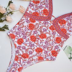 Sparkling rose all day in pretty Rosa One Piece Swimsuit. Feminine one piece swimwear features colorful flower print stretch fabric. This classic cut floral bathing suit offers the perfect amount of bottom coverage. Swim or lounge because you can enjoy it in and out of the water. Congratulations, you are one of the first to try our new swim collection! Details: Classic cut Rosa One Piece Swimsuit Bust is padded and wire free This style runs small, we recommend sizing up one full size from your t Beachy Swimwear With Floral Print And Stretch, Beachy Stretch Swimwear With Floral Print, Floral Print Stretch Tankini For Sunbathing, Stretch Floral Print Tankini For Sunbathing, Red Printed Tankini For Summer, Red Floral Print Swimwear For Pool, Red Floral Summer Swimwear, Red Floral Print Summer Swimwear, Red Floral Print Triangle Top Swimwear