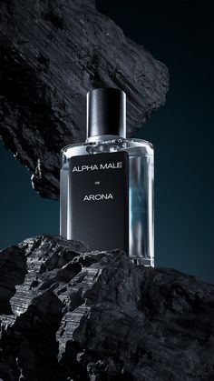 a bottle of perfume sitting on top of a rocky cliff next to a rock formation