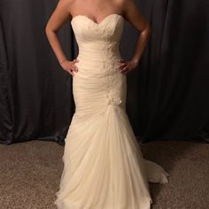 a woman in a wedding dress posing for the camera