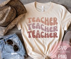 a t - shirt with the words teacher on it next to some hats and sunglasses