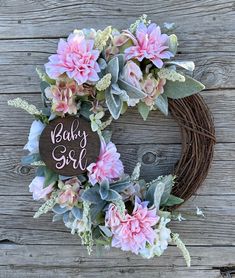 a baby girl wreath with pink flowers and greenery