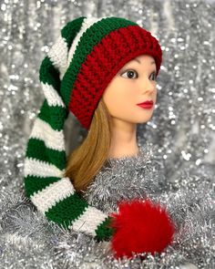 a doll wearing a christmas hat and scarf