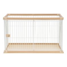 a small white bird cage with wooden sides and bottom bars on the side, in front of a white background