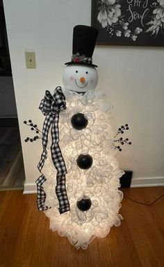 a snowman made out of buttons on the floor