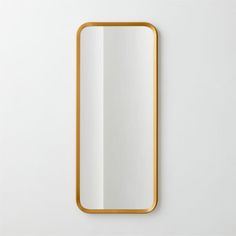 a gold framed mirror hanging on the wall next to it's own white background