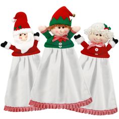 three christmas dolls are dressed in white and red