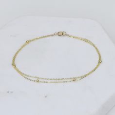 "14K Gold Dainty Multi Chain Bracelet - 14K Gold Double Chain Bracelet - 14K Solid Gold Bracelet ★ The chains and all components are 14K solid yellow gold ★ The tiny round beads are 1.7mm The length includes the chain and the closure. Please measure your wrist before you place your order. ** How to choose a correct size of bracelet. 1. Measure your wrist below the wrist bone using a flexible tape measures, a string or a strip of paper. 2. If using a string or a strip of paper, mark length. Then, Gold Bracelets With Satellite Chain As Gift, Gold Bracelets With Satellite Chain For Gift, Delicate 14k Yellow Gold Chain Bracelet, Dainty Gold Sterling Silver Bracelet, 14k Gold Filled Satellite Chain Bracelet, Gold Bracelet With Satellite Chain As Gift, Gold Satellite Chain Bracelet As Gift, 14k Gold Bracelets With Satellite Chain, Gold 14k Gold-filled Satellite Chain Bracelet