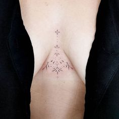 a woman's breast with small tattoos on it