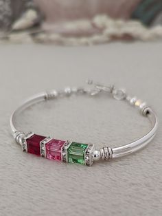 This family birthstone bracelet is the perfect way to celebrate Mother's Day. This could be gifted to Mom, Grandma, daughter, friend, or anyone in your life that's special to you. Birthstone jewelry represents family, and family is one of the most precious things in life!  ABOUT THIS ITEM: * 6mm austrian crystals * sliver rhinestone squaredelles * silver plated tube beads * pewter toggle clasp * rose, peridot and ruby crystals are used in the photos above PURCHASING OPTIONS: * birthstone months Adjustable Jewelry For Mom's May Birthstone Gift, Personalized Adjustable Crystal Bracelet For Anniversary, Adjustable Crystal Bracelet For Anniversary On Mother's Day, Sterling Silver Birthstone Bracelets For Mother's Day, Adjustable Birthstone Bracelets As Gift For Mom, Adjustable Birthstone Beaded Bracelets For Anniversary, Birthstone Crystal Bracelet For Mother's Day Gift, Adjustable Birthstone Crystal Bracelet For Mother's Day, Mother's Day Adjustable Birthstone Crystal Bracelet