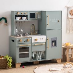 a child's play kitchen with an oven and sink