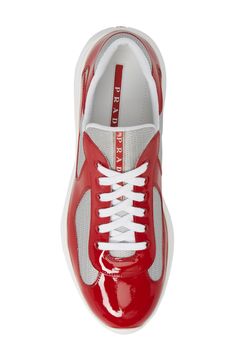 Modern mesh inlays add a touch of texture to a sporty sneaker formed from high-shine patent leather. Style Name:Prada Americas Cup Sneaker (Men). Style Number: 725998. Sporty Sneakers, Americas Cup, Sneaker Men, Leather Style, Patent Leather, Rubber Sole, Prada, Men's Shoes, In Italy