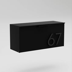 a black mailbox with the number 76 on it's front and side panels