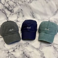 These are not cheap hats! These hats have thick, garment dyed fabric and leather buckles with quality embroidery. Each hat is custom made with your selections in Memphis by me. If you have a request for a design or want a different saying on the hat or would like the "dad" bigger or smaller, please send me a message and we can get started on a custom order! >> Hat Details << ■100% garment-washed cotton  ■Leather strap with antiqued brass buckle ■6-panel, unstructured, low-profile ■Tuck-away leather back strap ■Cool-Crown™ mesh lining >> Pictured is the charcoal hat with white thread color << Casual Flat Bill Hat Gift, Adjustable Dad Hat Baseball Cap For Father's Day, Personalized Curved Brim Baseball Cap For Father's Day, Personalized Casual Trucker Hat For Father's Day, Casual Trucker Hat For Father's Day, One Size Fits Most Dad Hat For Father's Day, Adjustable Hats As Father's Day Gifts, Adjustable Curved Brim Hat For Father's Day, Personalized Hats For Father's Day