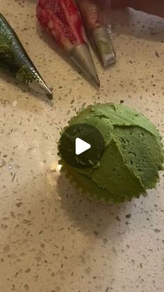 a green cake sitting on top of a counter