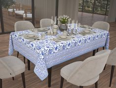 the table is set with plates and silverware on it, along with several chairs