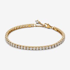 Choose a modern spin on a classic style with the Sparkling Tennis Bracelet. This 14k gold-plated bracelet sparkles with 48 round prong-set stones. Adjustable and dynamic, this cubic zirconia tennis bracelet features one sparkling stone dangling from beside the clasp for the perfect finishing touch. Designed with slightly larger stones than our other tennis bracelet styles, this bracelet is perfect for making a fresh statement when stacked with other bracelets in mixed tones and styles. - Pandora Sparkling Tennis Bracelet - 14k Gold-plated unique metal blend / Cubic Zirconia / Clear - Sz. 7.9 in Bracelet Styles, Xmas Wishlist, Bracelet Tennis, Mum Birthday, Birthday List, Gold Plated Bracelets, Pandora Bracelet, Lab Created Diamonds, Tennis Bracelet