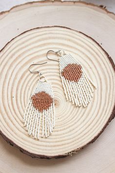 "These hand beaded earrings are made with delica seed beads in cream and pumpkin colors. Hanging from silver colored ear wires, they measure 3\" in length. Hand woven with durable high quality thread!" Adjustable White Beaded Tassel Earrings, Beaded Beige Dangle Jewelry, Handmade Cream Beaded Earrings With Round Beads, Handmade Cream Beaded Drop Earrings, Handmade Cream Beaded Earrings, Natural Beaded Dangle Jewelry, Beige Beaded Dangle Jewelry, Natural Color Beaded Dangle Jewelry, White Handwoven Drop Earrings