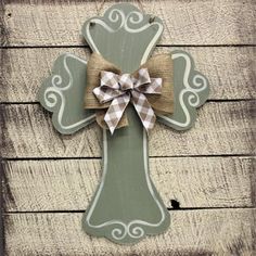 a wooden cross with a bow on it