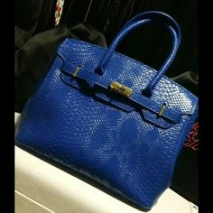 Available In 3 Colors: Black, Blue, And Pink Width: 15" Height (Including Handle): 14" Inner Bag Depth: 8.5" Inner Bag Width (Fully Open) 12" Removable Strap Blue Rectangular Office Bag, Rectangular Blue Office Bag, Luxury Blue Bag With Hasp Closure, Blue Large Capacity Satchel For Evening, Luxury Blue Top Handle Bag, Large Capacity Blue Satchel For Evening, Luxury Large Capacity Blue Satchel, Blue Top Handle Bag With Hasp Closure, Luxury Blue Shoulder Bag With Top Carry Handle