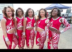 a group of women in red and white outfits standing next to each other with their hands on their hips