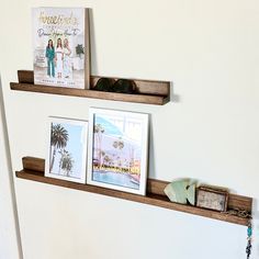 two wooden shelves with pictures and other items on them