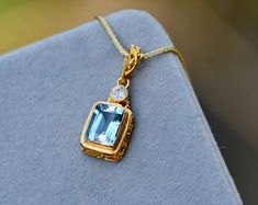 This delightful natural emerald cut aquamarine necklace is a serene blue set in solid 18k gold. Paired with a lovely 0.8mm 18k solid gold wheat chain it is hard to find a natural stone as full of life as this. What makes this even more crave worthy is the lovely diamond it is paired with. This spectacular piece of jewelry that will be treasured for years to come.  Size : 20x9mm Chain Length : choose from dropdown Material : 18k Gold Gemstone : Genuine Natural AAA Aquamarine & Diamond More about Blue Emerald Cut Gemstone Necklace, Blue Emerald Cut Necklace Fine Jewelry, Blue Emerald Cut Fine Jewelry Necklace, Formal Aquamarine Pendant Jewelry, Emerald Cut Blue Necklace As A Gift, Blue Emerald Cut Necklace For Gift, Emerald Cut Blue Necklace For Gift, Light Blue Sapphire Jewelry Gift, Rectangular Blue Topaz Jewelry Gift