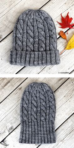 two knitted beanies sitting on top of a wooden floor next to autumn leaves