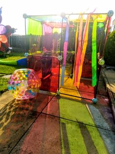 an assortment of balloons and streamers on the ground