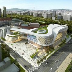 an aerial view of a large building with green roof