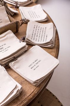 there are many napkins that have been folded on top of each other with writing on them