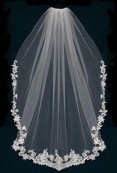 a white veil with flowers on the bottom and lace at the top is shown in front of a black background