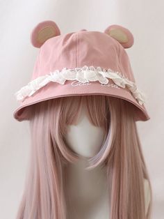 a pink hat with white lace on the brim and ears is sitting on a mannequin head