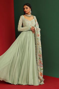 Jade long anarkali in  georgette base with floral embroidered bodice and sleeves. Comes with floral printed dupatta with hand made tassels.
Component: 2
Pattern: Printed, Embroidered
Type Of Work: Floral Pattern
Neckline: V-Neck
Sleeve Type: Full
Fabric: Georgette, Organza, Shantoon
Color: Green
Other Details: 
Circular tassel hem dupatta
Back plunged neck
Frayed lace hem neckline
Occasion: Wedding - Aza Fashions Anarkali Set With Intricate Embroidery In Georgette, Georgette Lehenga With Intricate Embroidery, Designer Anarkali Set With Intricate Embroidery In Georgette, Intricate Embroidery Georgette Lehenga, Intricate Embroidery Georgette Lehenga Maxi Length, Intricate Embroidered Georgette Lehenga Maxi, Semi-stitched Sheer Dupatta Gown In Georgette, Anarkali Set With Intricate Embroidery In Pista Green, Georgette Salwar Kameez For Reception