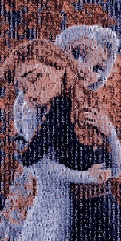 two people are hugging each other in front of an image of the same man and woman