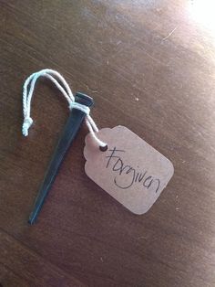 a wooden table topped with a piece of paper and a metal object on top of it