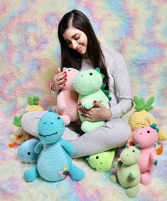 a woman is holding several stuffed animals in her hands