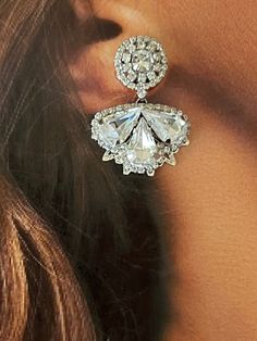 Our LEXES earrings are absolutely gorgeous and timeless to wear for a classic look. The silhouette consists of a a bigger floral design filled with crystals shaped in a leaf form to add a fine look. These will add a touch of sparkle to a stylish look. Handcrafted Highest Quality Swarovski / Cubic Zirconia Platinum plated Guards against scratches and tarnish. approximate size 1.15" length 1" width Nickel free Free Shipping in USA Glamorous Crystal Flower Earrings For Wedding, Diamond Chandelier Earrings For Evening, Formal Cubic Zirconia Flower Drop Earrings, Elegant Flower Shaped Clip-on Earrings For Party, Dazzling Crystal Embellished Cubic Zirconia Earrings, Elegant Crystal Earrings In Flower Shape, Wedding Jewelry With Rhinestones In Flower Shape, Elegant Crystal Flower-shaped Earrings, Elegant Crystal Flower Earrings For Party