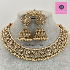 White Antique Polki Kundan necklace set/Reverse Ad Necklace/Statement necklace/Indian/Punjabi Necklace/Pakistani Jewelry/Bridal necklace/ Antique Reverse Ad Stone Necklace With Mehndi Plating Regular Size And Adjustable Stone Necklace Antique Necklace Set with dull gold finish  This is 100% Handmade jewelry. So Color, shades, texture displayed may slightly vary from the actual product due to digital image limitations. We request you to consider these minor variations. Please expect the possibility of some slight imperfections when buying hand made jewelry. If you have any questions, please message or email us. Arrives in gift box. Please let me know if you have any questions. Thank you so much visiting my shop. Traditional Heavy Round Jewelry Sets, Heavy Kundan Necklace For Ceremonial Occasions During Eid, Bollywood Style Ceremonial Jewelry Sets, Round Kundan Necklace With Tilla For Eid, Heavy Necklace For Eid Celebration, Heavy Temple Jewelry Necklaces For Eid, Heavy Necklaces For Eid Celebration, Wedding Necklaces With Latkans For Eid, Heavy Round Bollywood Necklaces