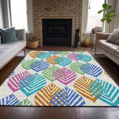 a living room with a large colorful rug on the floor