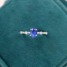 ❥ RING DESCRIPTION :- ✦ Handmade, high-quality item! ✦ Material: SOLID 14K/18K/24K GOLD (can be made in white/rose/yellow gold) ✦ Center Stone: Simulated Tanzanite  ✦ Stone Shape: Oval Cut ✦ Dimensions:- 6X8 MM ✦ Color: Blue ✦ Side Stone: Cubic Zirconia  ✦ Color: Transparent ✦ Clarity: Eye Clean  ❥ FINISHES :- ✦ 925 Sterling Silver, 22k Yellow Gold, Rose Gold, White Gold or Black Gold Plating.  ❥ NOTE :-  ✦ Due to the nature of the gemstones, the appearance of each piece may slightly vary in color and pattern. ✦ The shades of each Sand-stone vary since they are natural and untreated. If you have a shade preference, please indicate it in the notes section. ✦ The Material Used In Making The Ring is Either 925 Sterling Silver (in all The Gold Plated Rings) ✦ And 14K\ 18k\ 24k Solid- Yellow Go Diamond Silver Ring, Sand Stone, Oval Cut Engagement Ring, Tanzanite Stone, Tanzanite Ring, Rose Yellow, Ring Oval, Ring Dainty, December Birthstone